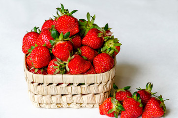 red strawberry in wicker bowl
