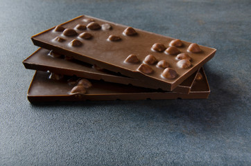 Milk chocolate with nuts on table