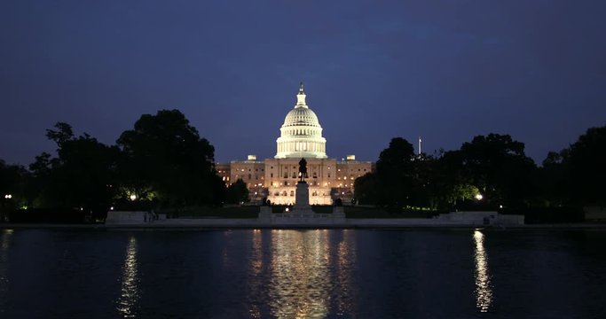 United States Capitol and the Senate Building over the reflecting pool at night in Washington DC USA