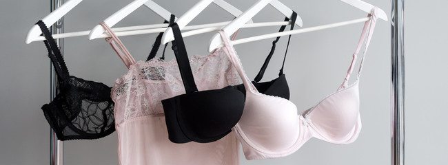 Vareity of bra hanging on a hanger. Textile, Underwear. Female bra in lingerie underwear store. Advertise, sale, fashion concept.
