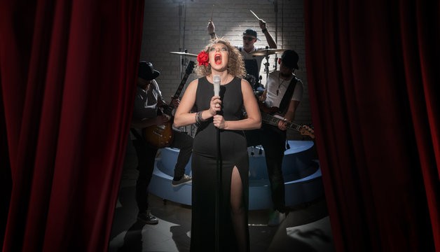 The girl with the rose in her hair sings loudly