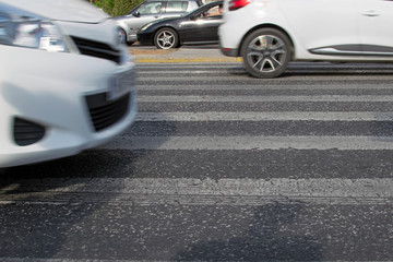 Lanes pedestrian crossing on asphalt, highway and a lot of cars. City traffic