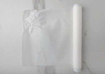 Crumpled white baking paper on the marble table