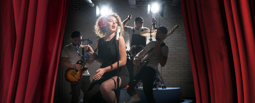 Musical group plays on stage