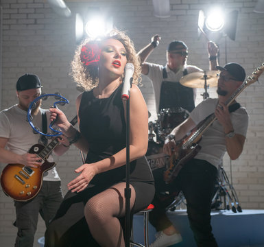 Woman with a tambourine sings the notes