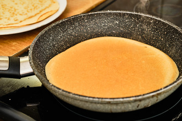 Cooking pancake on frying pan