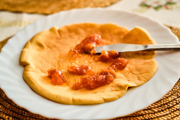 Greasing pancake with marmalade
