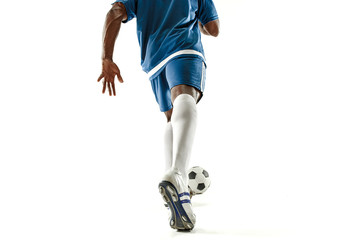 Fototapeta premium The legs of soccer player close-up isolated on white. African american model in action or movement with ball. The football, game, sport, player, athlete, competition concept