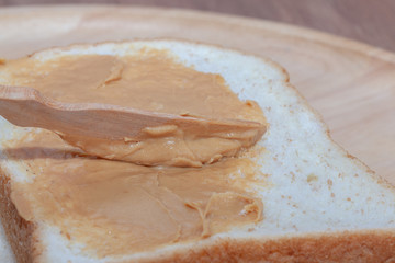 Peanut butter sandwich bread on wooden plate