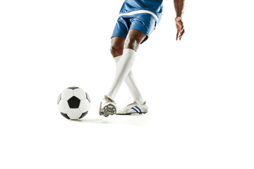 The legs of soccer player close-up isolated on white. African american model in action or movement...