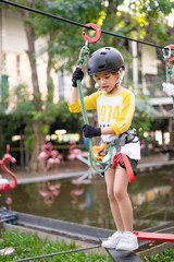 Happy school girl enjoying activity in a adventure park