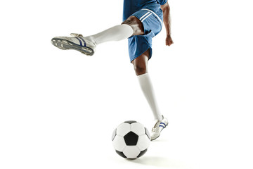 Obraz premium The legs of soccer player close-up isolated on white. African american model in action or movement with ball. The football, game, sport, player, athlete, competition concept