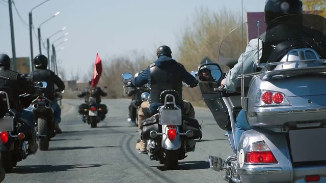 many subculture bikers group ride on the track on a Sunny summer day on custom motorcycles, a large-scale action of motorcyclists