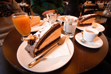 Wooden table with gigantic cake, coffee, sugar and juice