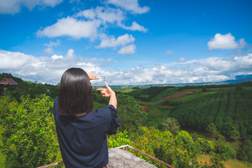 Fototapeta na wymiar Happy young cute asian Japanese girl hipster backpack photography women taking a photo at beautiful sky mountains scenery views 