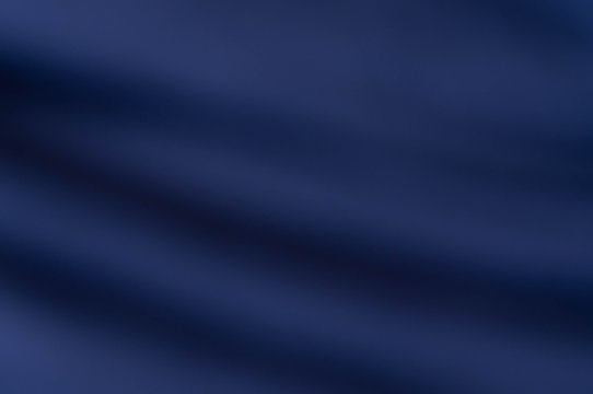 soft blurred mysterious dark blue fabric texture background