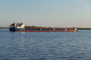 a ship with oil floats along the river