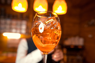 Bartender preparing alcoholic aperitif, aperol spritz cocktail