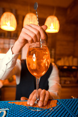 Bartender preparing alcoholic aperitif, aperol spritz cocktail