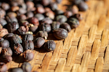sun dry coffee cherry beans on bamboo mat 