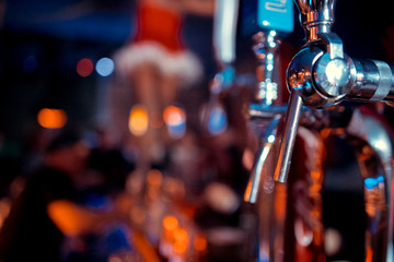 Shiny beer taps in a row in a bar
