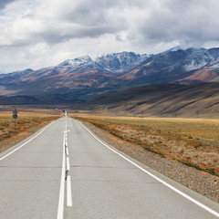Landscape with the outgoing road against the backdrop of the Altai Mountains