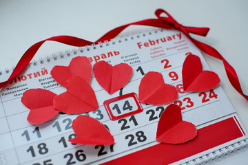 Calendar to Valentines day with red paper hearts