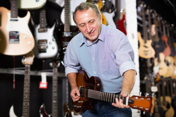 Male is playing on electric guitar