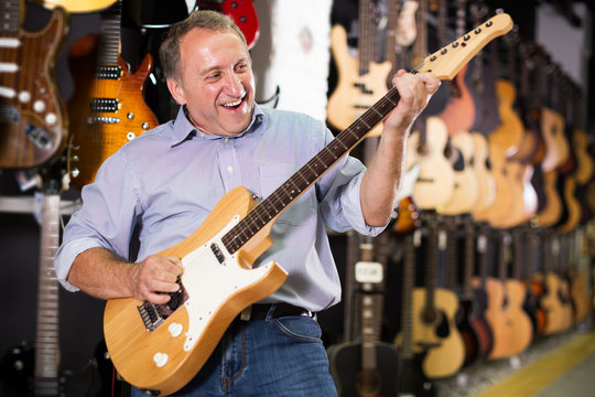 Man is playing on electric guitar