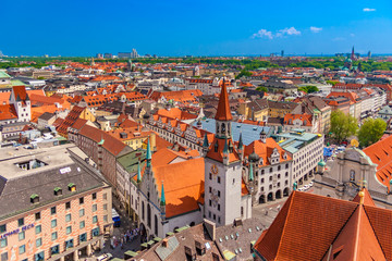 Fototapeta na wymiar Beautiful aerial view of Munich's cityscape with focus on the Talburg Gate (Talburgtor) at the Old Town Hall (Altes Rathaus) in the front centre on a nice sunny day with a blue sky in Germany.