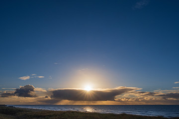 Fototapeta na wymiar Sonne und Wolken über der niederlädischen Nordsee
