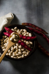beans in clay basil on a table with ingredients for preparation