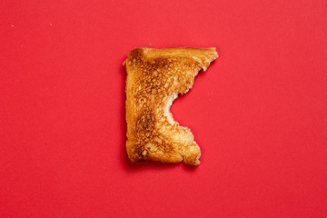 bitten toast on red background