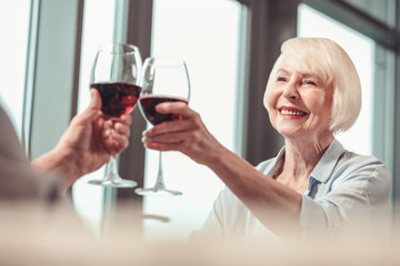 Beautiful retired lady drinking wine with a man