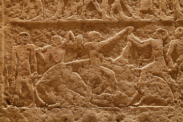 Stone wall with carved ancient Egyptian bas relief