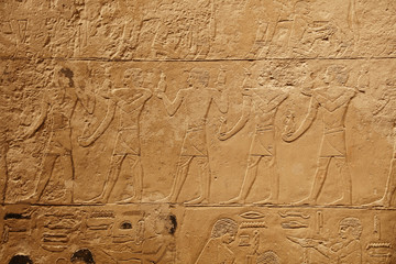 Stone wall with carved ancient Egyptian bas relief