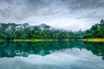Zelfklevend Fotobehang Misty morning on Cheow Lan Lake, Khao Sok National Park, Thailand © daboost