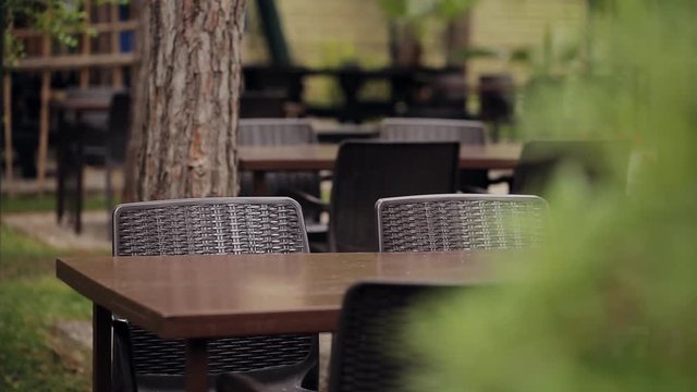 Plastic chairs and plastic tables in the forest caf&eacute; in the open air.