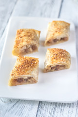 Slices of apple strudel on the white plate