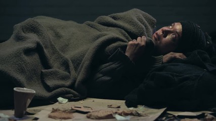 Crying emigrant lying on street, dreaming about home and family, losing hope