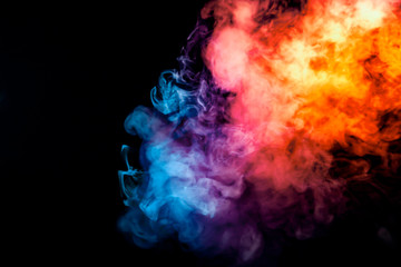 The thick smoke exhaled from the vape is highlighted by a blue-violet orange color like a rainbow...