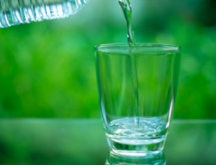 Drinking water in a glass on a wooden table