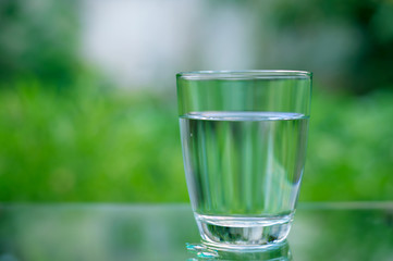 Drinking water in a glass on a wooden table