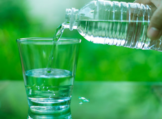 Drinking water in a glass on a wooden table