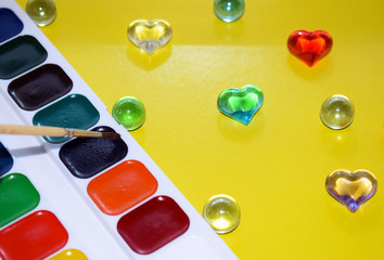 Painted hearts on yellow background. Watercolor paint and brush artist. Valentine's day.