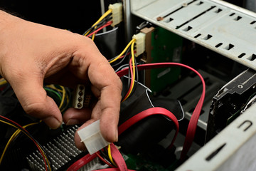 Engineer is repairing electric wire computer hardware in a computer CPU