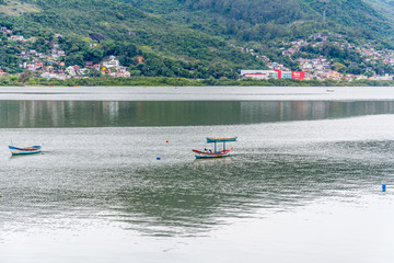Obraz premium Small fisher boats on water, in Florianopolis, Brazil.
