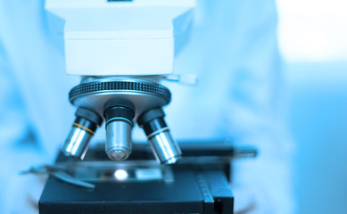 doctor supervisor looking at the microscope slide in the forensic,Laboratory Medical scientists working at lab with test tubes researcher performs liquid