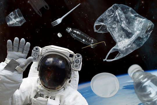 Space debris, pollution of the atmosphere of the planet Earth and space by human waste. Plastic debris in space and an astronaut in  spacesuit. Elements of this image furnished by NASA