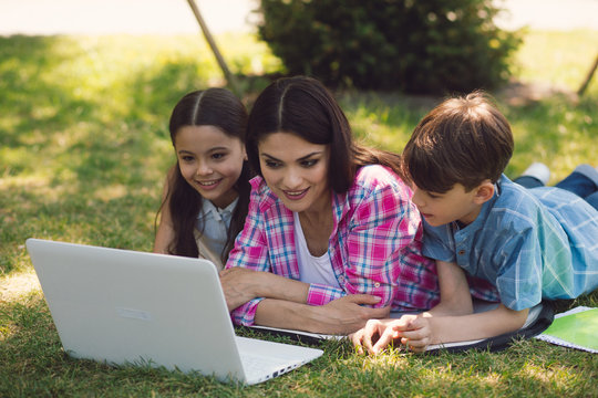 A Teacher Giving Lesson With Laptop In Park